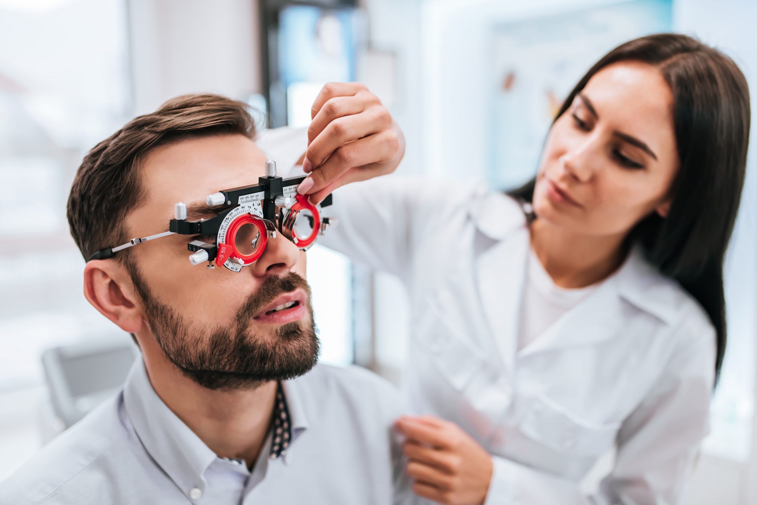 Man has his vision tested by female doctor